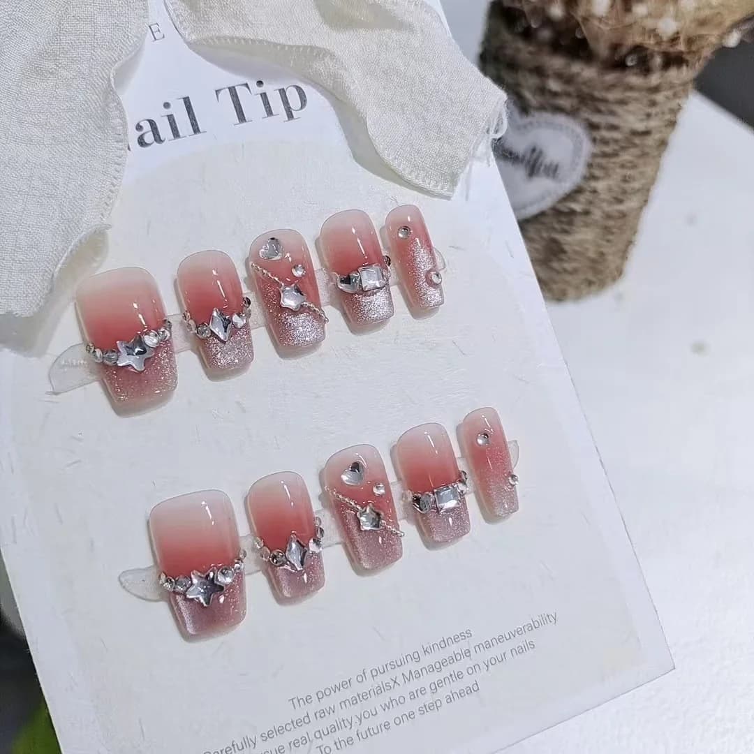 Móng tay dán họa tiết trái tim và nhũ lấp lánh